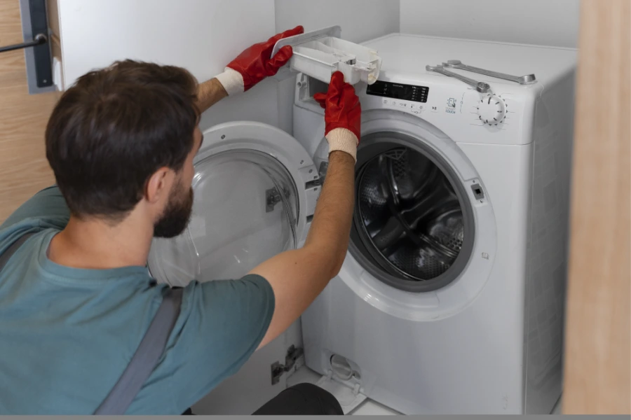 Washer repair technician servicing a washing machine in Concord NC