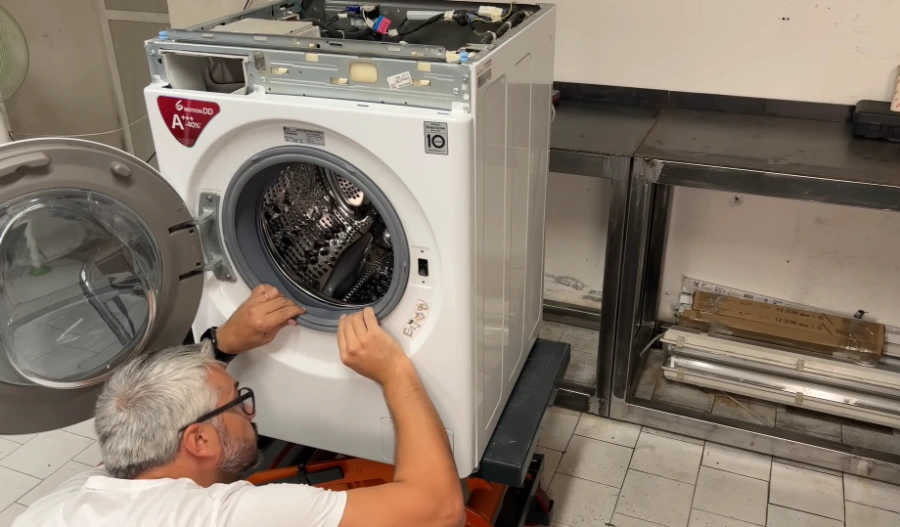Technician diagnosing a loud washing machine