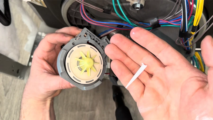 Dishwasher drain pump impeller showing vanes and housing interior