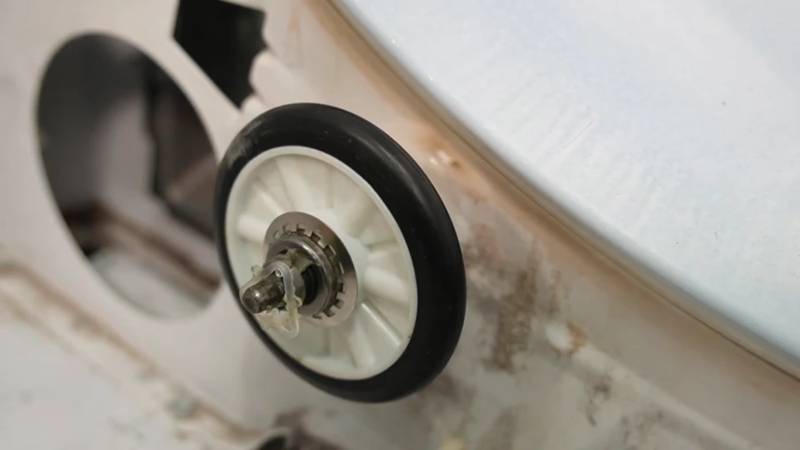 New roller wheel being installed on dryer drum support bracket