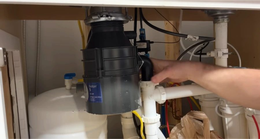 Garbage disposal drain connection and P-trap showing typical leak points
