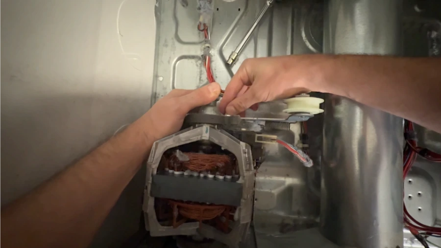 New idler pulley being installed on a dryer