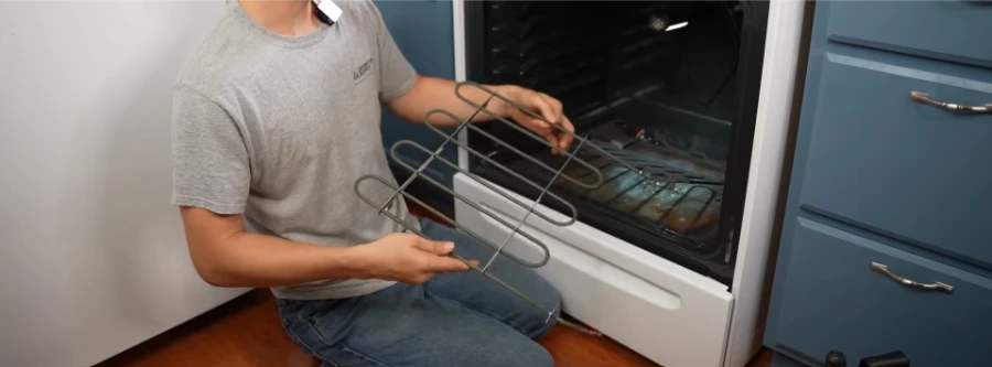 Technician replacing an electric oven bake element