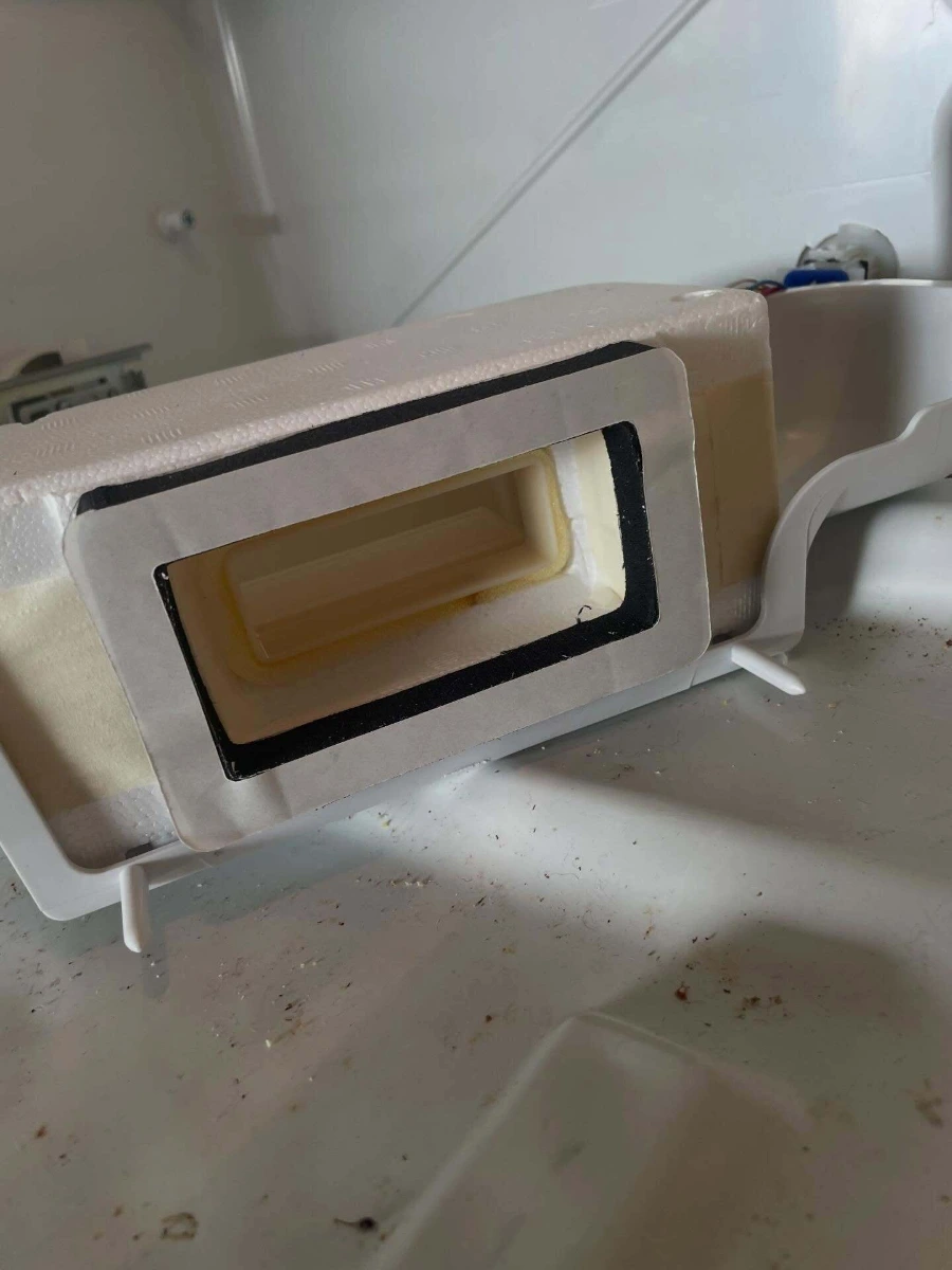 Fresh food damper assembly removed from a refrigerator during a diagnostic service inspection
